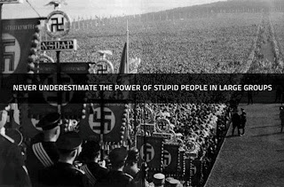 Never underestimate the power of stupid people in large groups.jpg